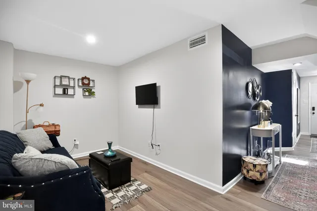 a living room with furniture and wooden floor