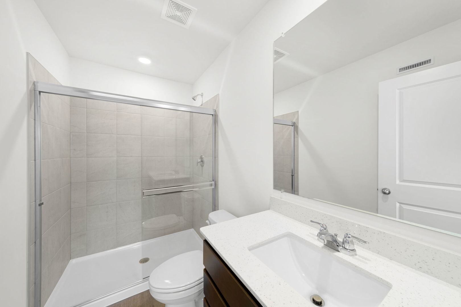 2121 Yellowstone Boulevard, Unit 2121 Mundelein, IL 60060 - Photo 8 of 10 a bathroom with a sink a toilet and shower
