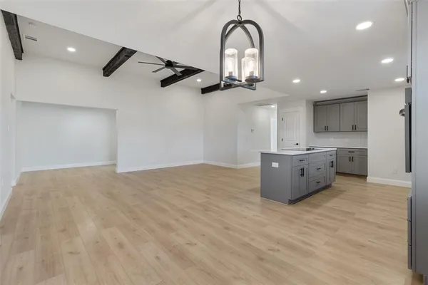 a kitchen with kitchen island a sink stainless steel appliances and cabinets