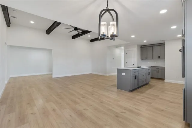 a kitchen with kitchen island a sink stainless steel appliances and cabinets