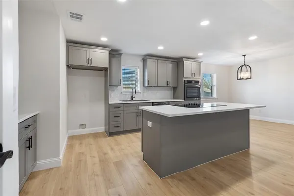 a kitchen with a stove a sink and a refrigerator