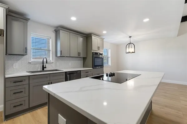 a kitchen with a sink window and cabinets