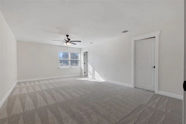 a view of a livingroom with a ceiling fan and window