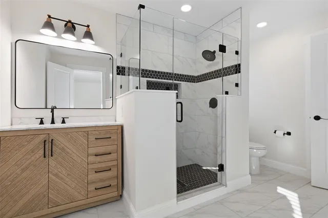 a bathroom with a toilet and a shower