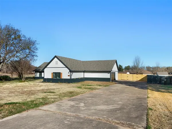 a view of a house with a yard and sitting area