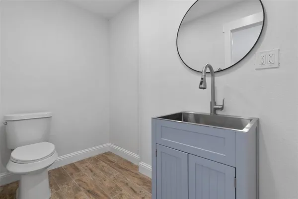 a front view of house with yard and trees in the background