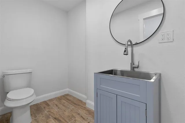 a front view of house with yard and trees in the background