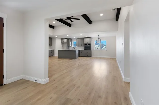 a view of a kitchen with a sink and microwave