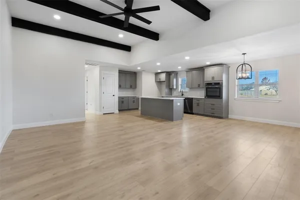 a large kitchen with cabinets and stainless steel appliances