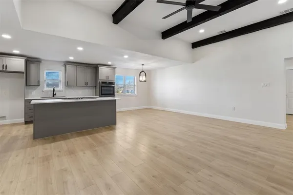 a view of a kitchen with a sink and cabinets