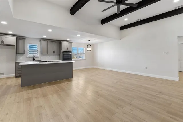 a view of a kitchen with a sink and cabinets