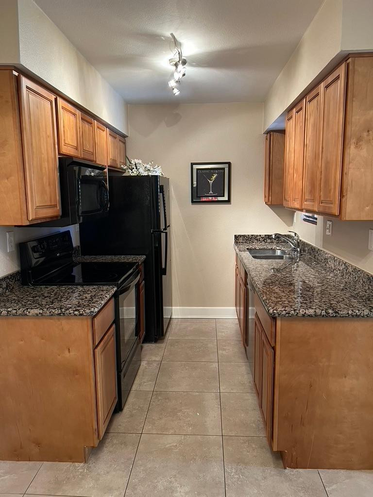 5877 North Granite Reef Road Scottsdale, AZ 85250 - Photo 2 of 10 a kitchen with granite countertop a stove and a refrigerator