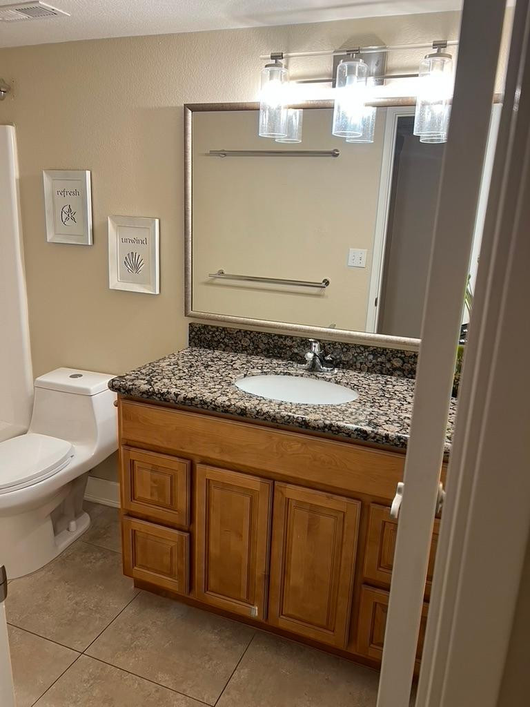 5877 North Granite Reef Road Scottsdale, AZ 85250 - Photo 4 of 10 a bathroom with a granite countertop toilet sink and mirror
