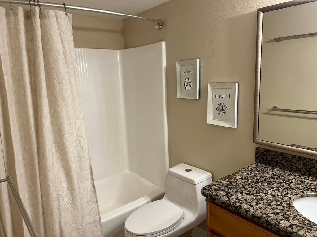 5877 North Granite Reef Road Scottsdale, AZ 85250 - Photo 5 of 10 a bathroom with a toilet and a shower curtain