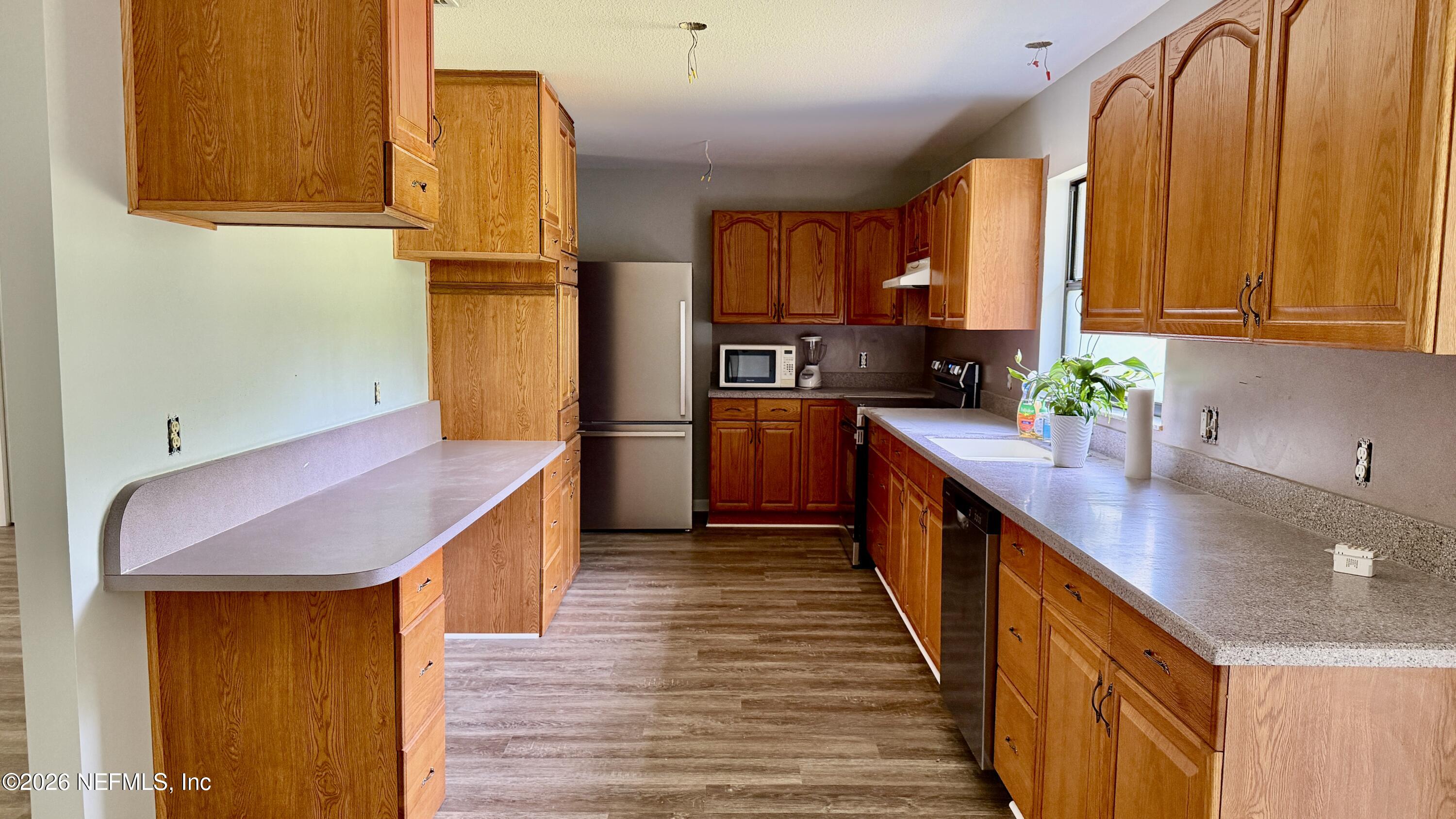 850 Cousintown Road Interlachen, FL 32148 - Photo 7 of 27 a kitchen with stainless steel appliances a sink and cabinets