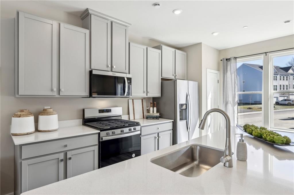 151 River Rdg Drive Moon Township, PA 15108 - Photo 11 of 24 a kitchen with stainless steel appliances granite countertop a sink a stove and a refrigerator