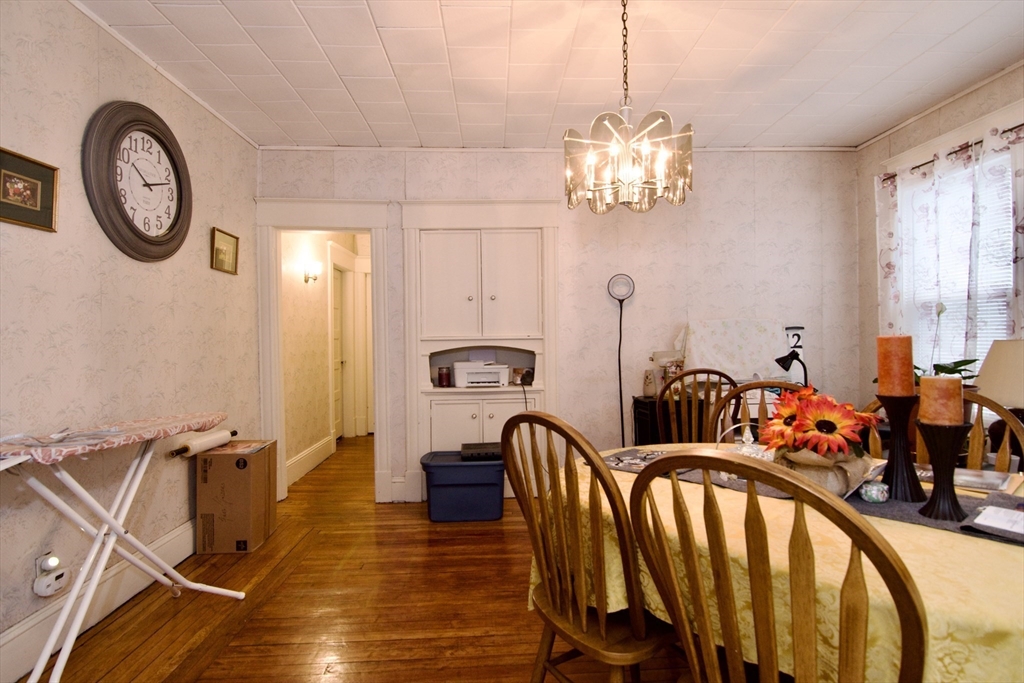 24 Longview Street Springfield, MA 01108 - Photo 8 of 34 a view of a dining room with furniture a chandelier and wooden floor