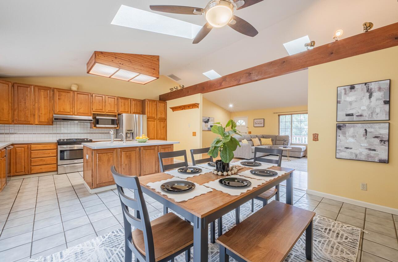 18191 Berta Canyon Road Salinas, CA 93907 - Photo 17 of 36 a kitchen with stainless steel appliances kitchen island granite countertop a table chairs and a refrigerator
