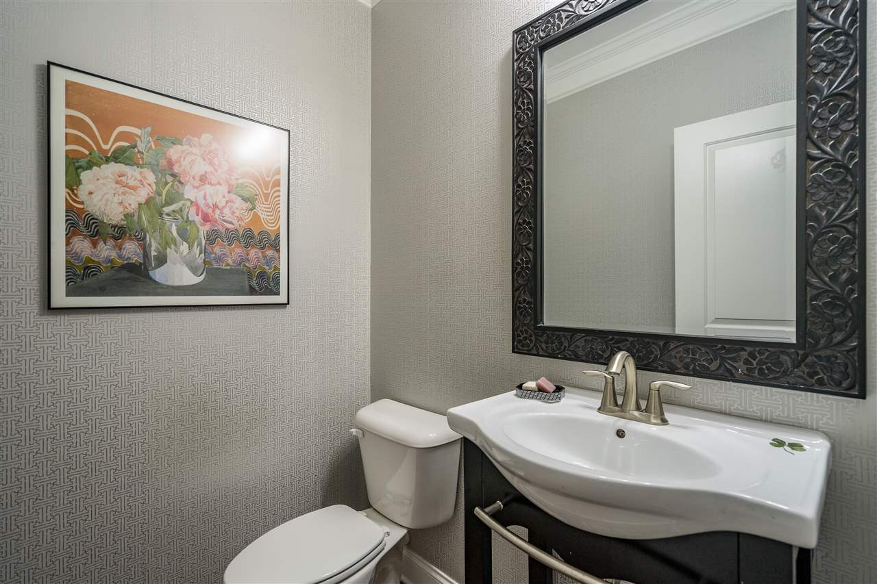 1400 Van Page Boulevard Raleigh, NC 27607 - Photo 21 of 30 First floor powder room with modern pedestal sink tucked away from the family room and eating areas! Powder Room