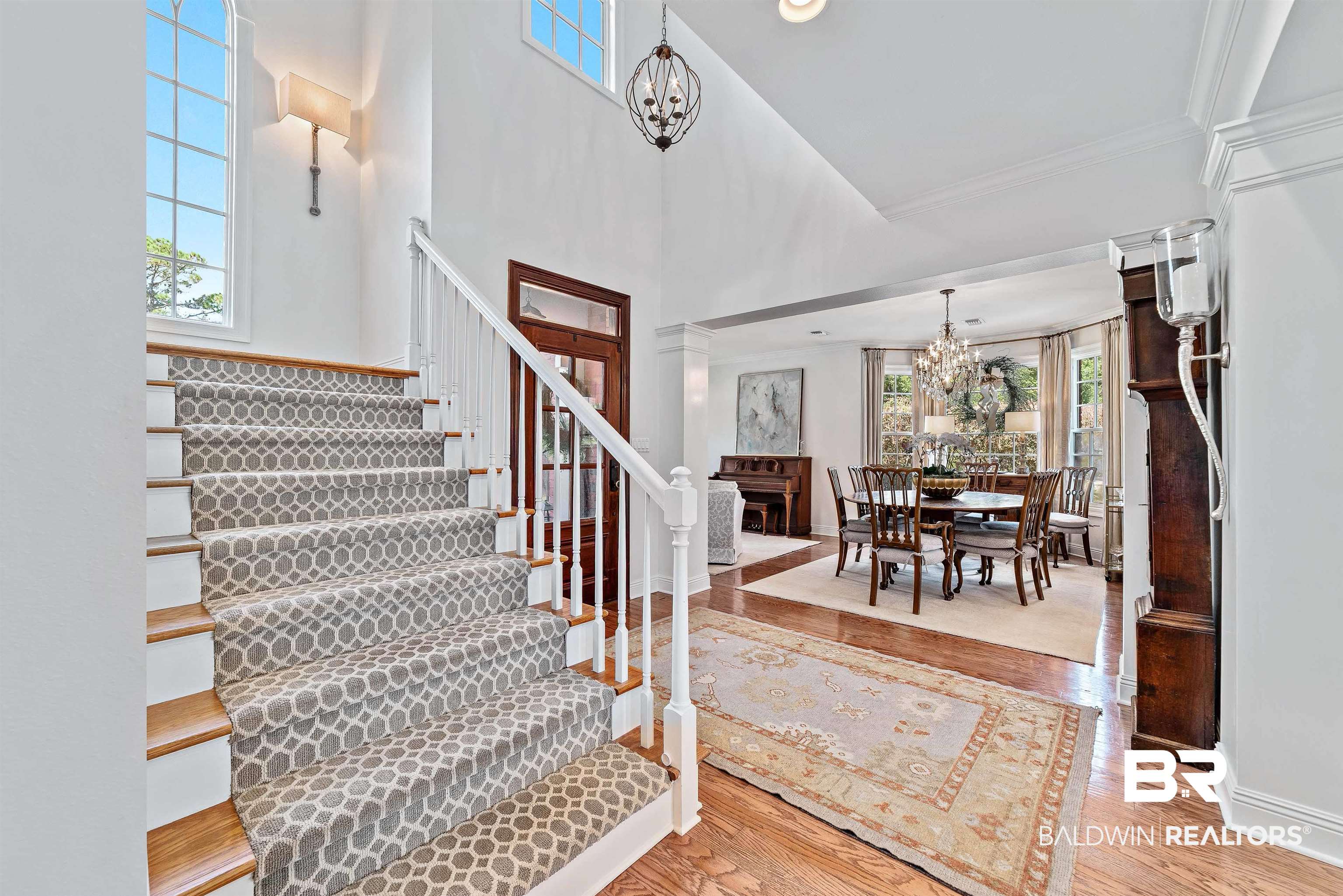 6630 East Quarry Drive Elberta, AL 36530 - Photo 19 of 63 Entrance foyer with light wood finished floors, a chandelier, a towering ceiling, and stairway