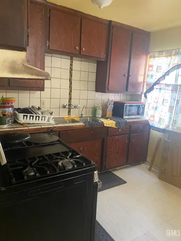 a kitchen with a stove and a refrigerator