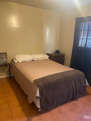 a bed sitting in a bedroom next to a window