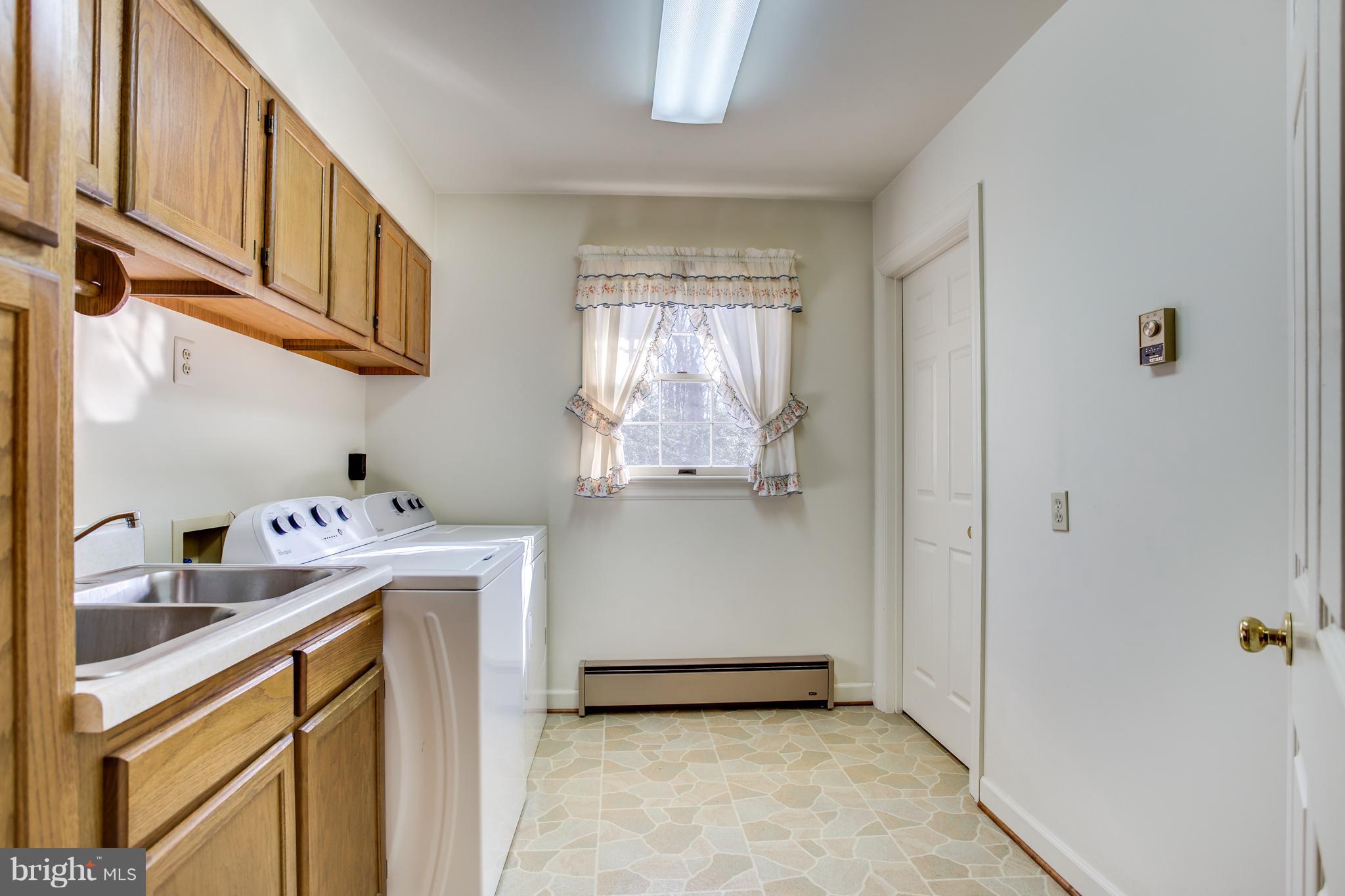 4950 Lansdowne Road Fredericksburg, VA 22408 - Photo 11 of 29 Laundry room with utility sink beside kitchen.