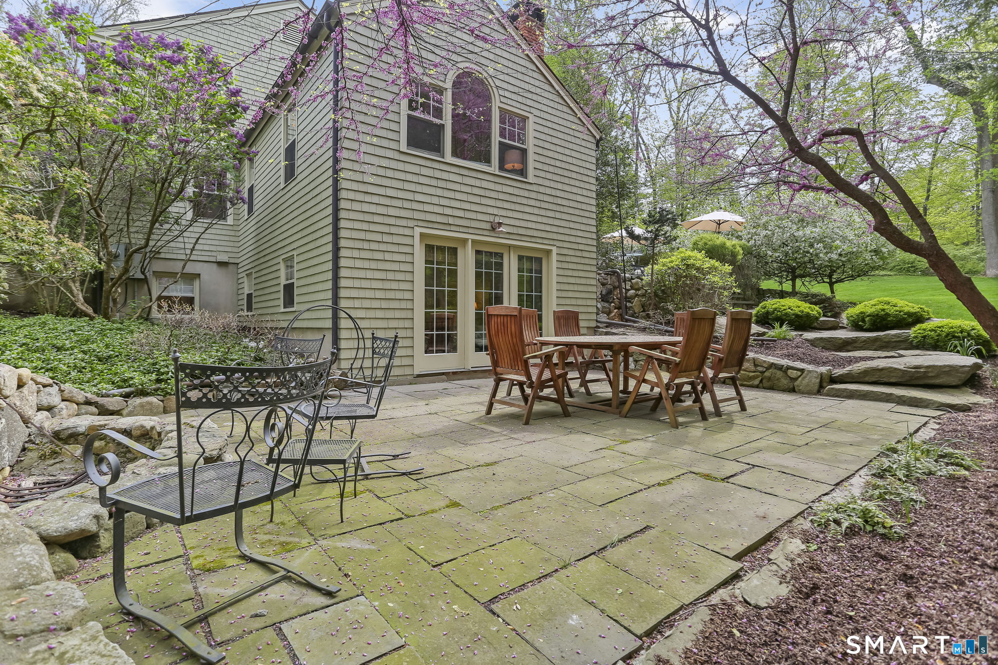 23 Old Stage Coach Road Weston, CT 06883 - Photo 34 of 37 a view of a chairs and tables in the back yard of the house
