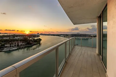 a view of a balcony with wooden floor and lake view