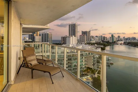 a view of a balcony with wooden floor and outdoor seating