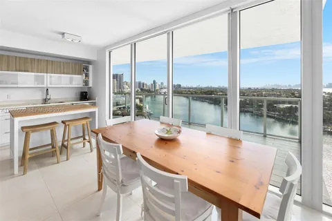 a view of a dining room with a table and chairs