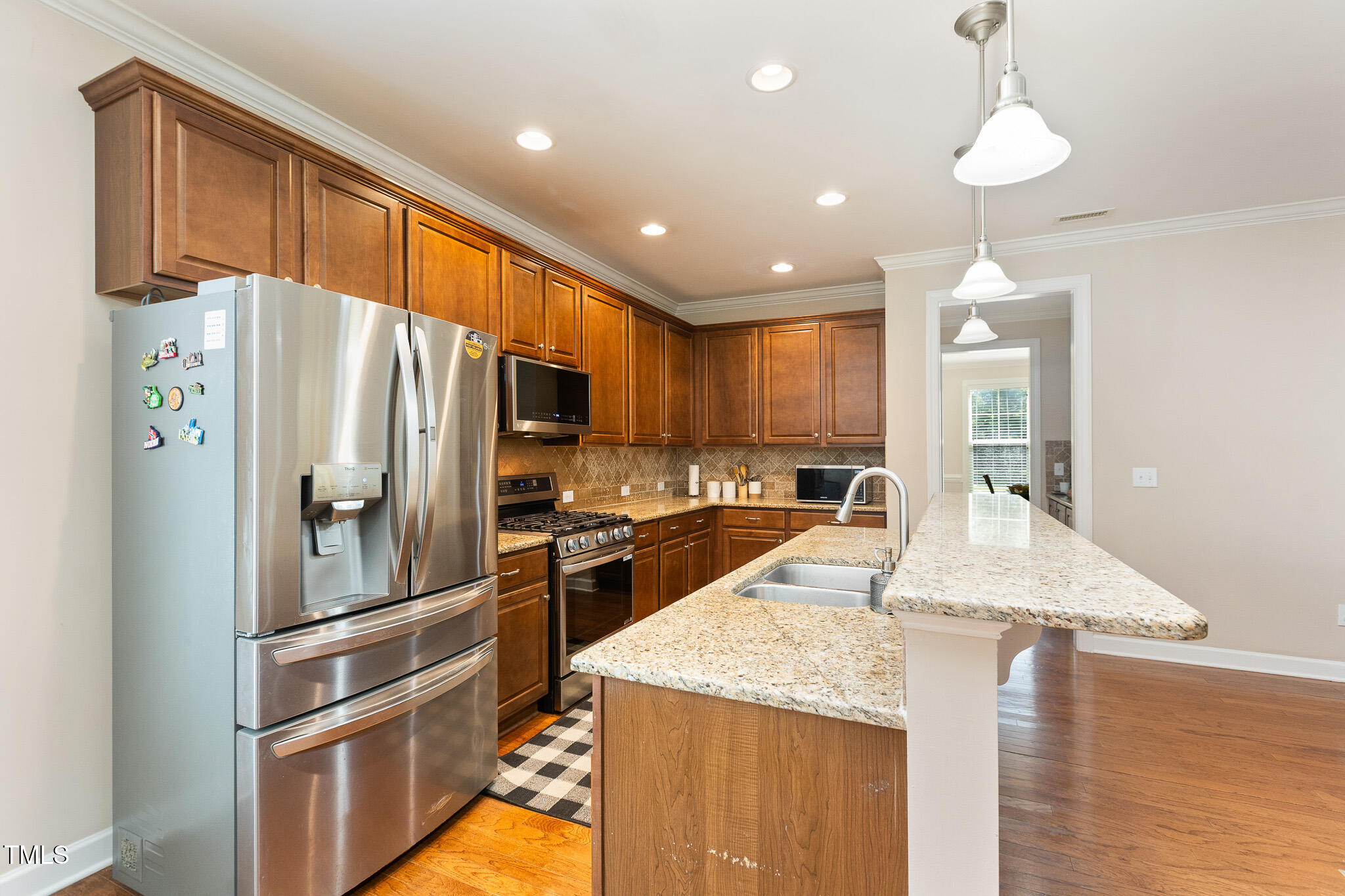 800 Chapanoke Road Raleigh, NC 27603 - Photo 11 of 39 a kitchen with granite countertop a refrigerator and a sink