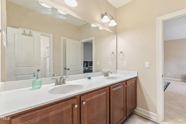 a bathroom with a sink double vanity and a mirror