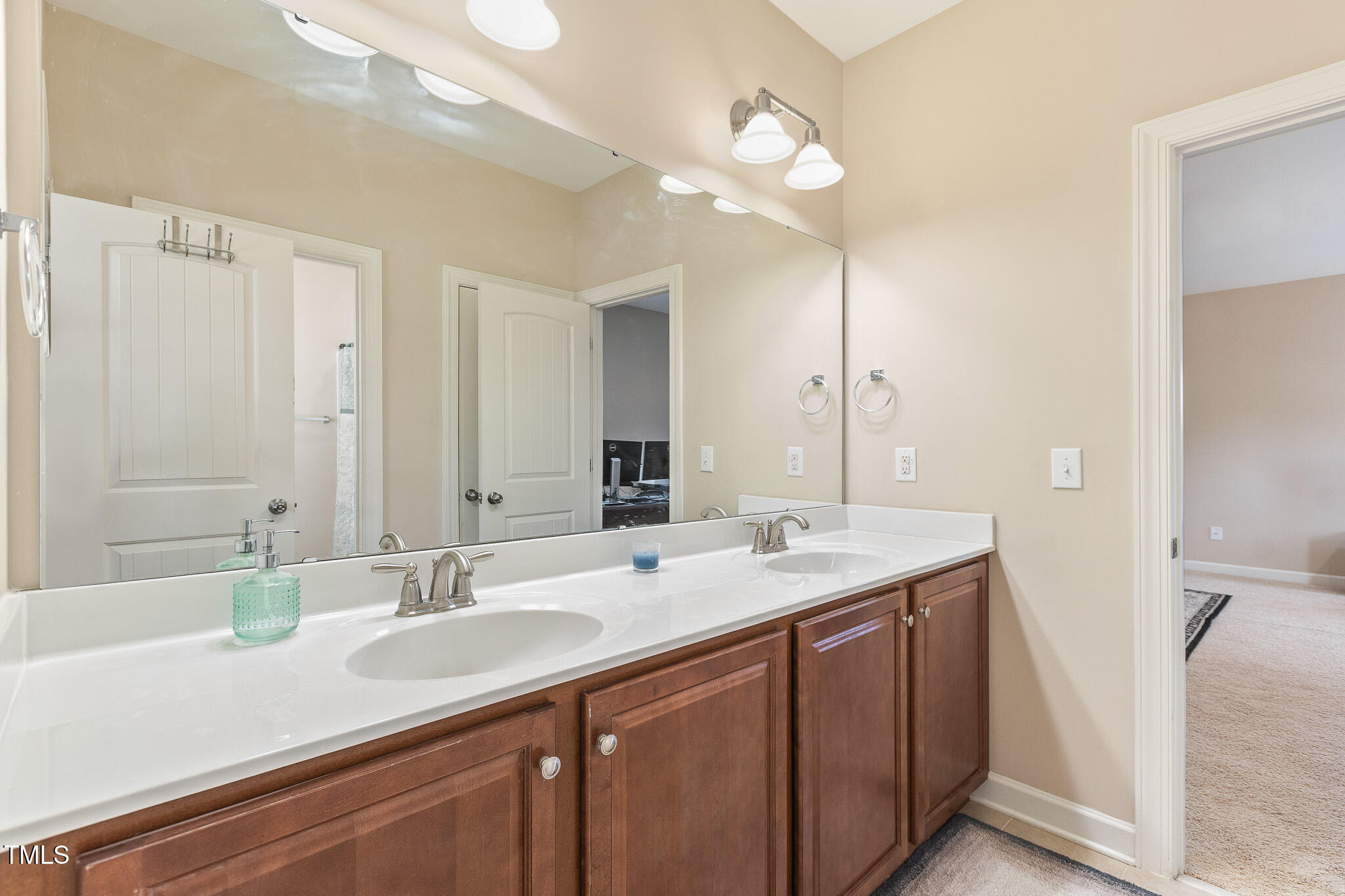 800 Chapanoke Road Raleigh, NC 27603 - Photo 23 of 39 a bathroom with a sink double vanity and a mirror