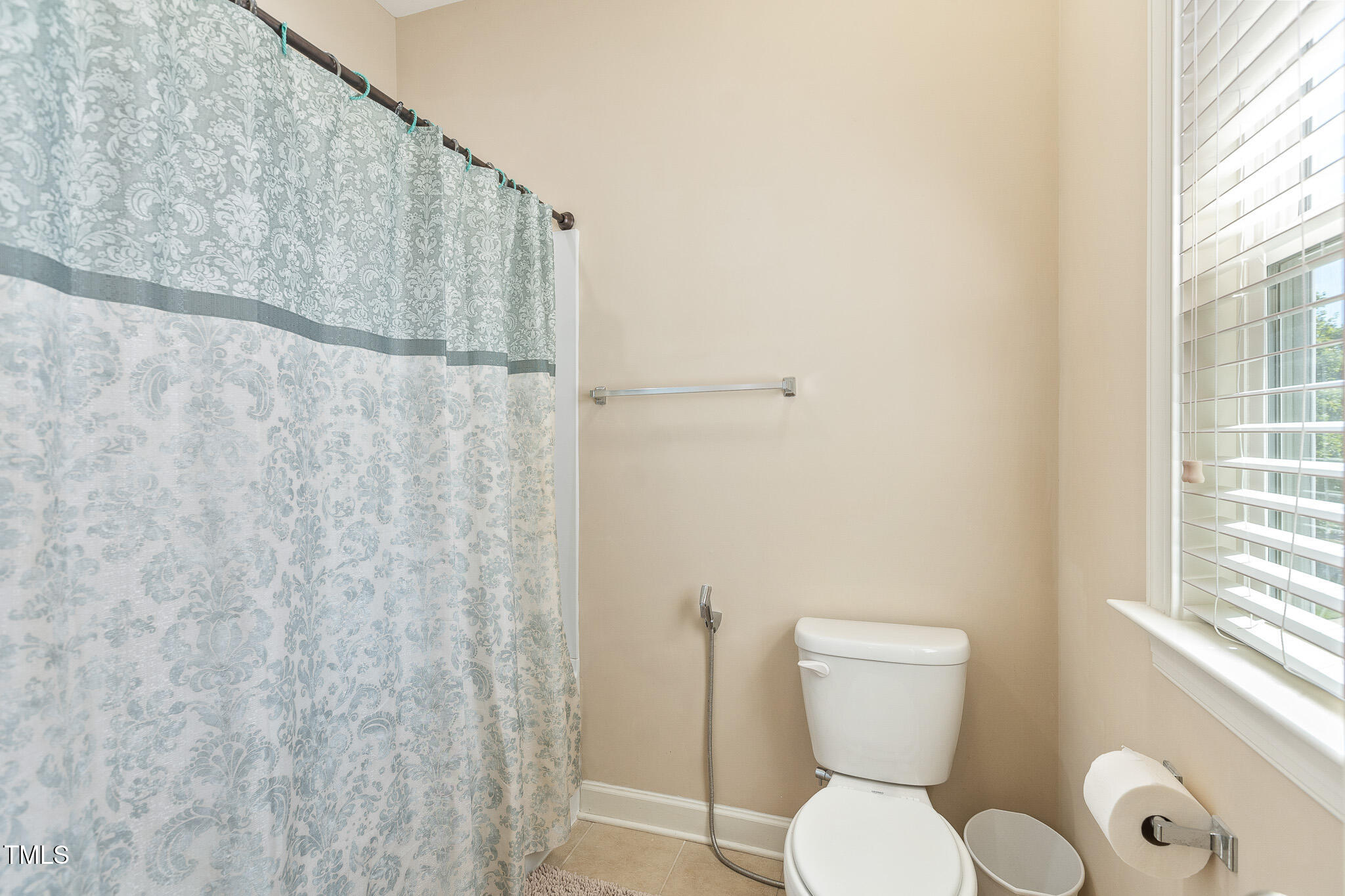 800 Chapanoke Road Raleigh, NC 27603 - Photo 24 of 39 a bathroom with a toilet and a shower curtain