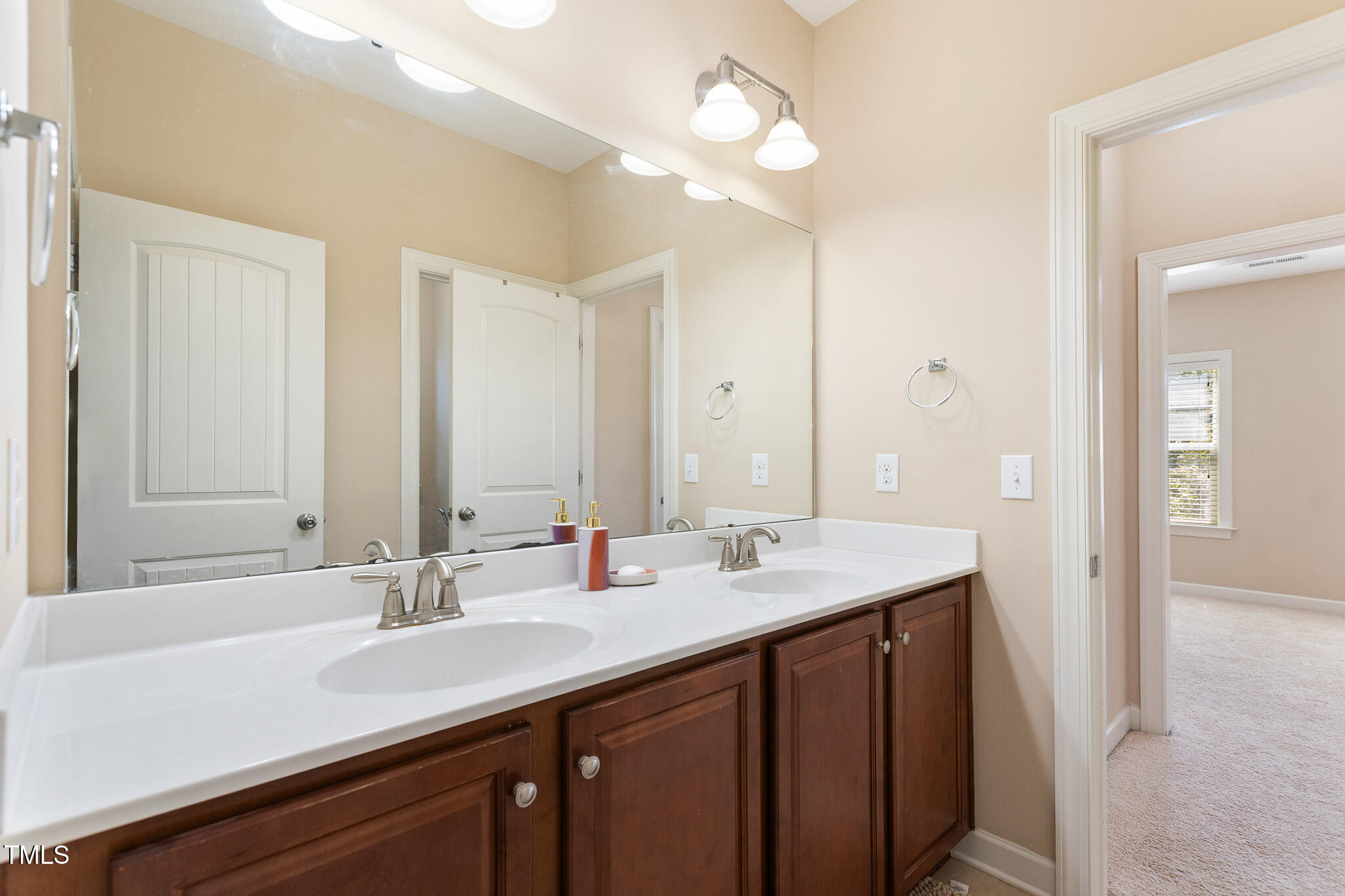 800 Chapanoke Road Raleigh, NC 27603 - Photo 29 of 39 a bathroom with a sink double vanity and a mirror