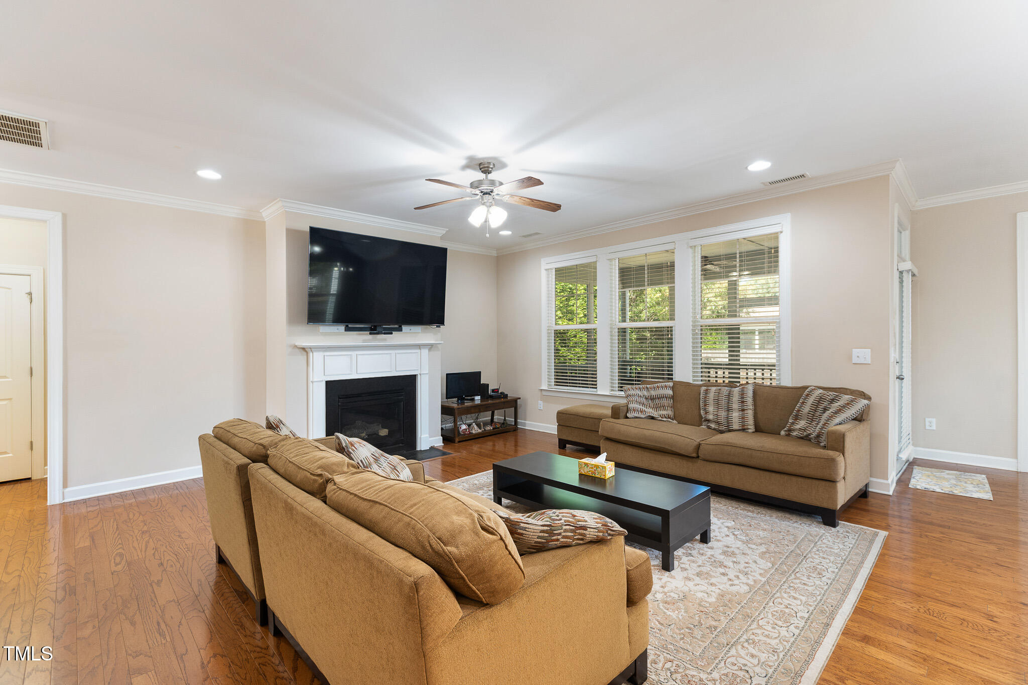 800 Chapanoke Road Raleigh, NC 27603 - Photo 7 of 39 a living room with furniture a fireplace and a flat screen tv