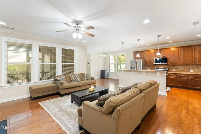 a living room with furniture and kitchen view