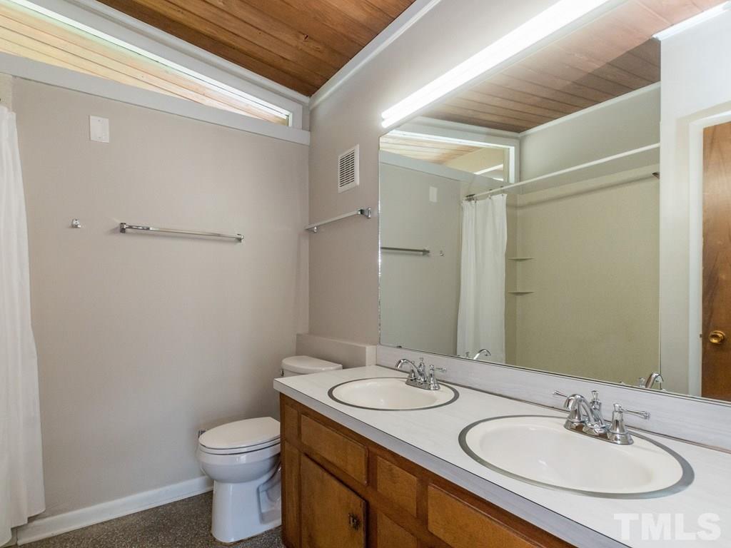 3612 Anclote Place Raleigh, NC 27607 - Photo 14 of 25 a bathroom with a sink toilet and shower