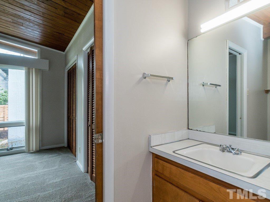 3612 Anclote Place Raleigh, NC 27607 - Photo 17 of 25 a bathroom with a sink and a mirror