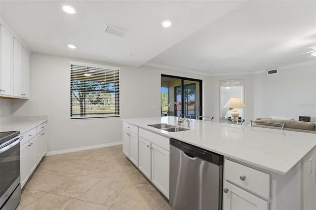 a living room with furniture ceiling and a ceiling fan