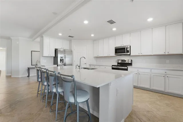 a spacious bedroom with a bed and a cabinets