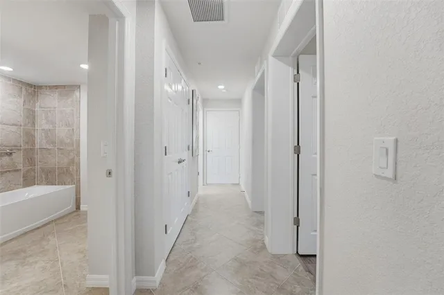 a front view of a house with a yard and a garden