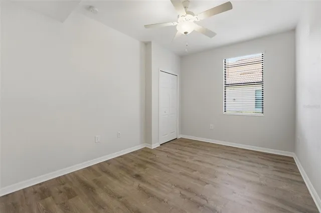 a view of swimming pool with a yard and palm trees