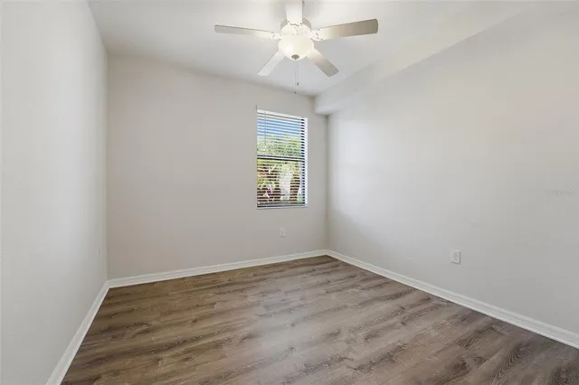 a view of a white house with a yard and potted plants