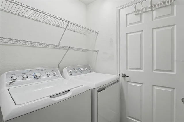 a front view of a house with a yard and potted plants