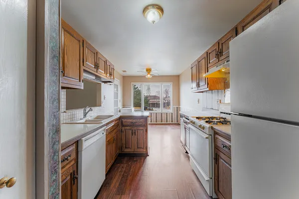 a kitchen with stainless steel appliances granite countertop a stove and a sink
