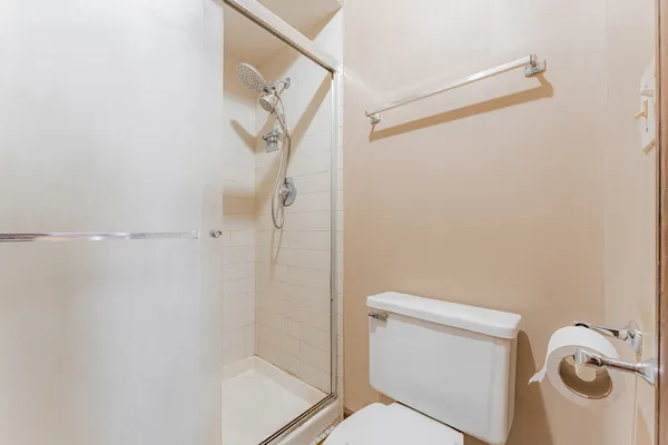 a bathroom with a toilet and a shower