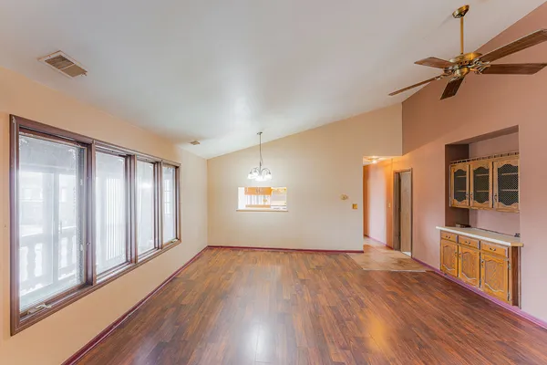 wooden floor in an empty room with a window
