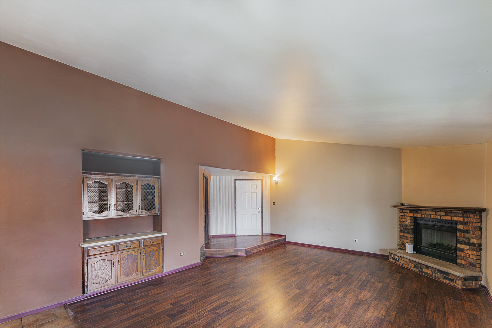 9724 West Creek Road, Unit B2 Palos Park, IL 60464 - Photo 5 of 22 an empty room with wooden floor fireplace and cabinet